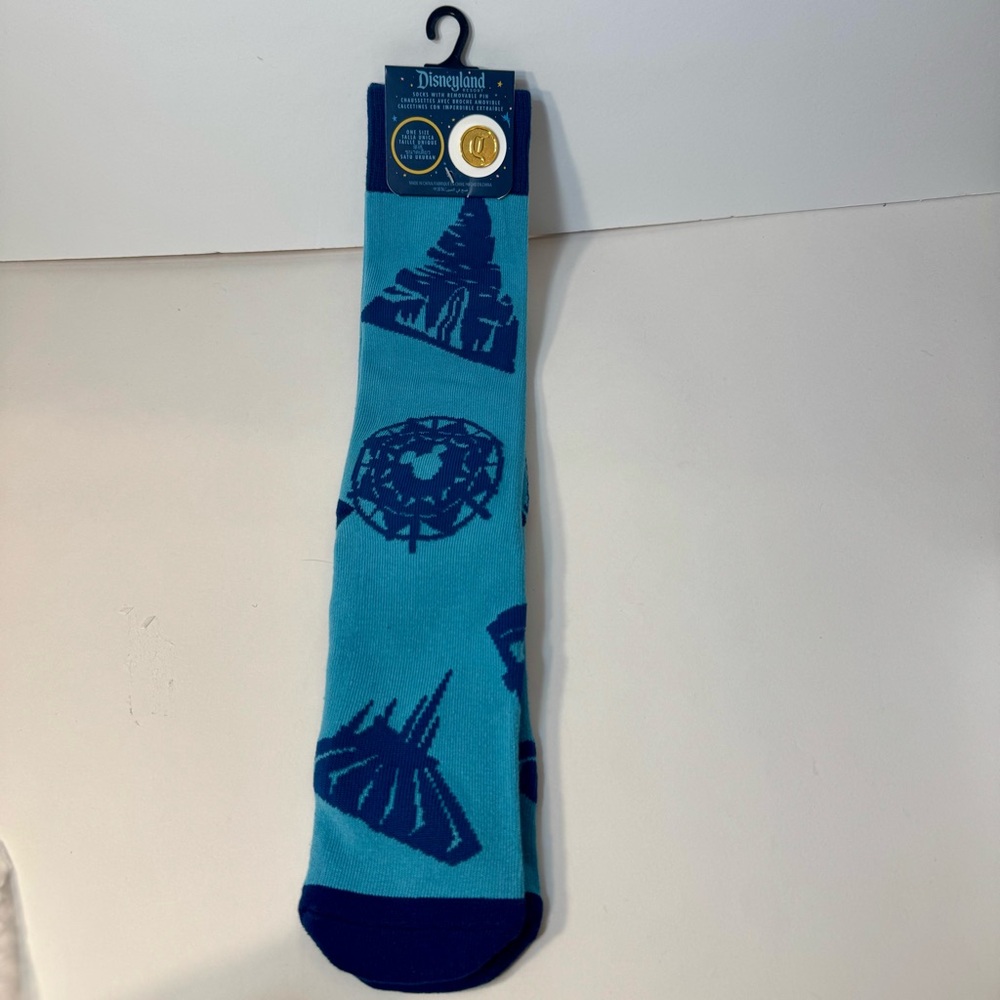 NWT. Disneyland  socks & pin. 1 pair of blue Disneyland-themed crew socks & pin